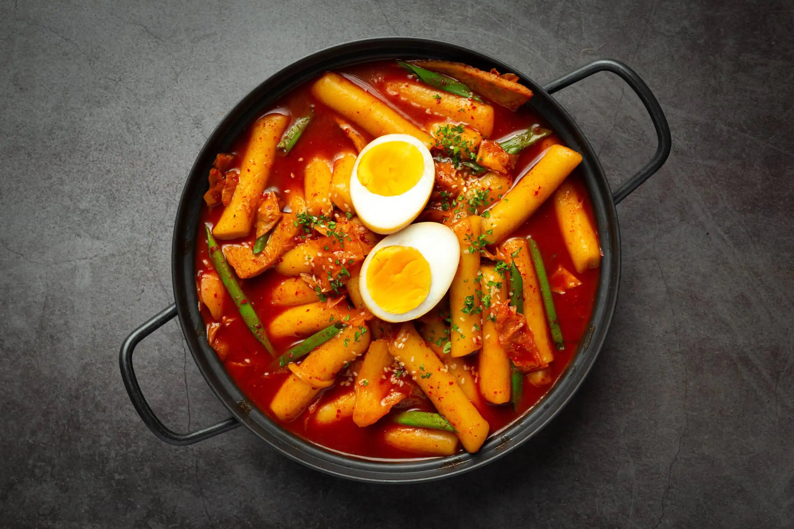 Chewy Korean rice cakes in spicy red chili sauce with vegetables