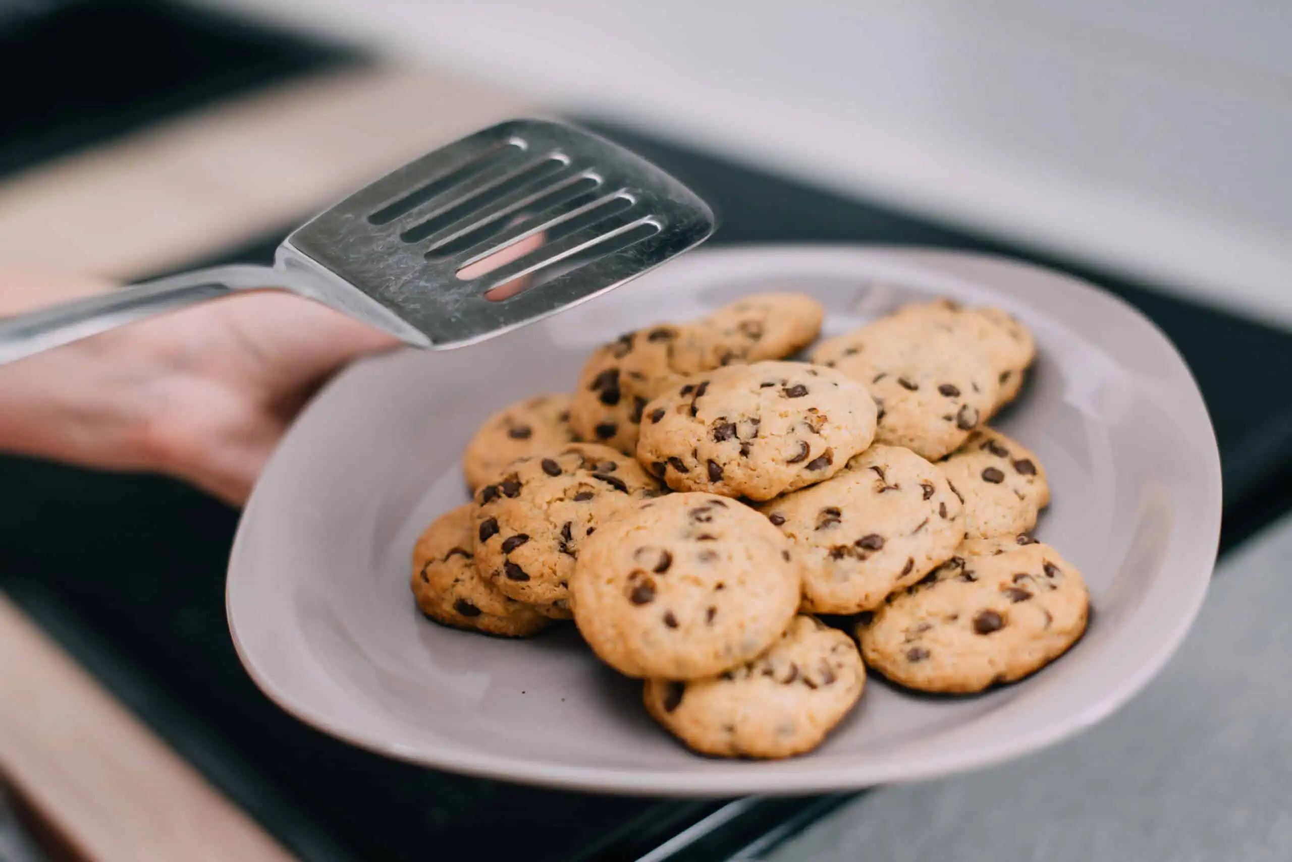 A tray of freshly baked cookies with golden-brown edges and soft centers.