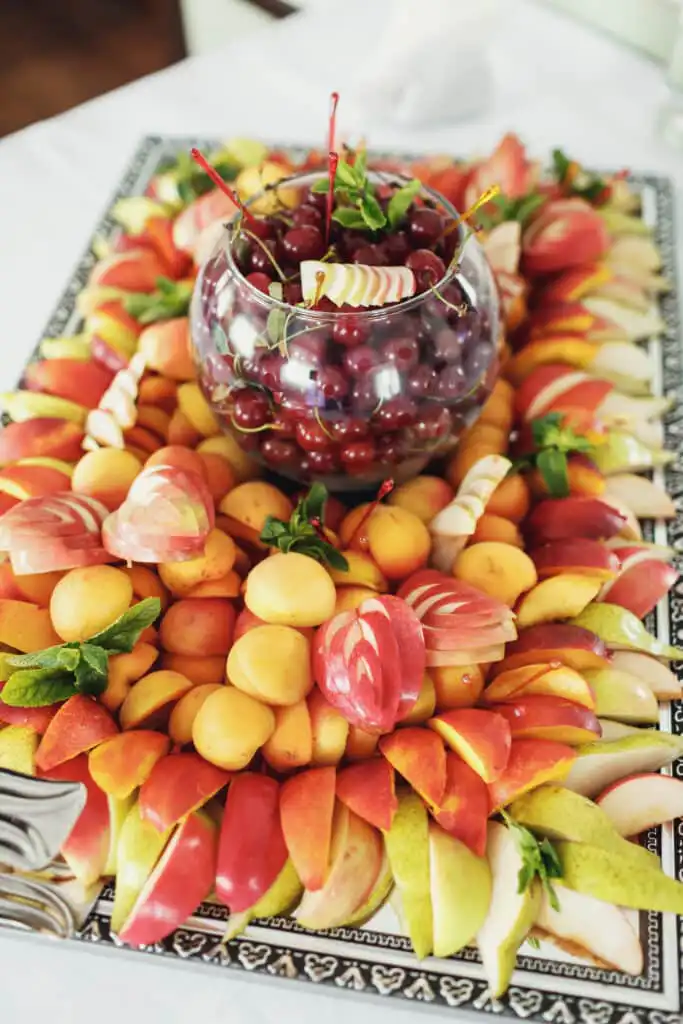 Image of a beautifully arranged fruit platter with a variety of colorful fruits, perfect for serving at a party.