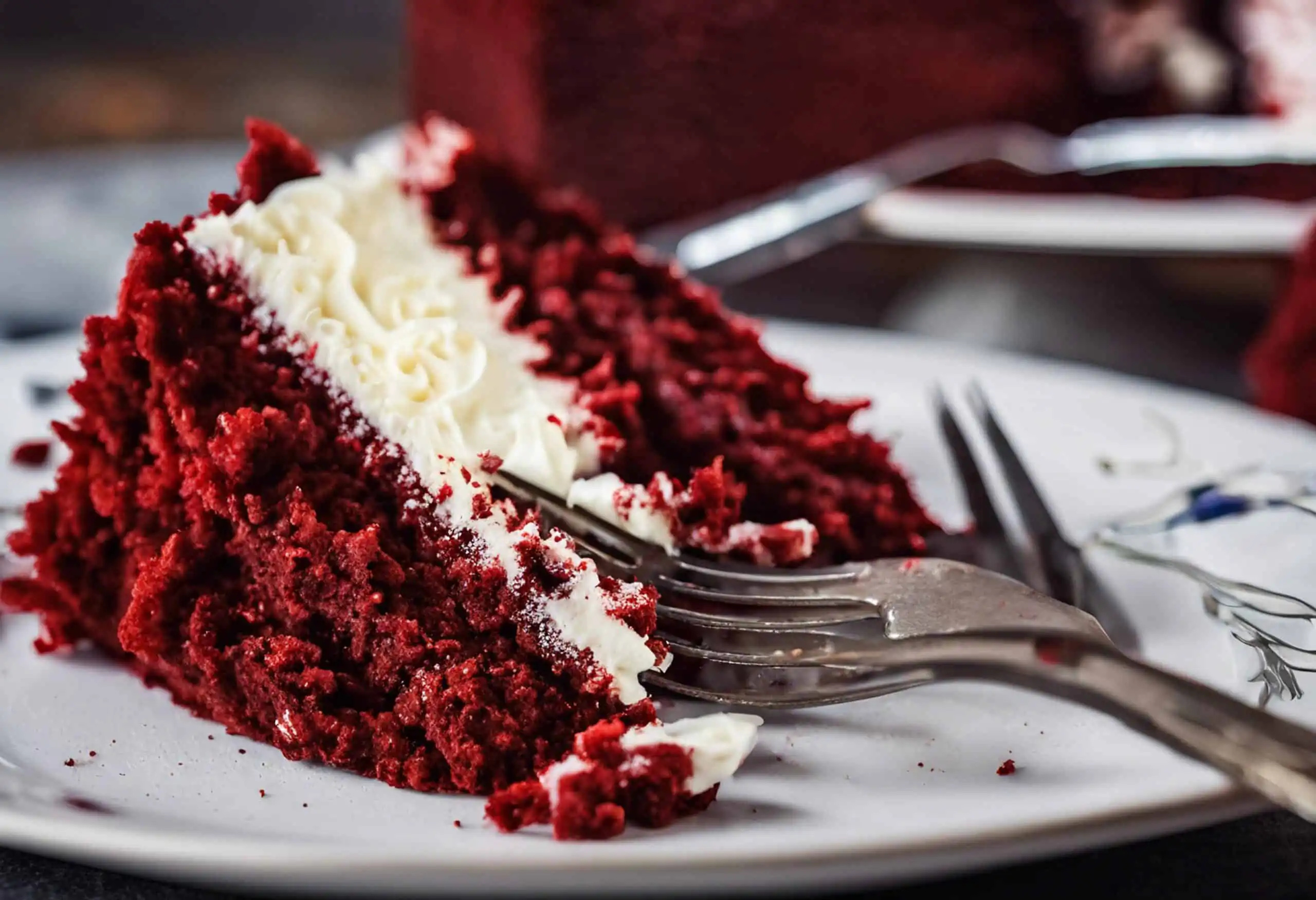 Red velvet brownies with cream cheese swirl on a white plate.