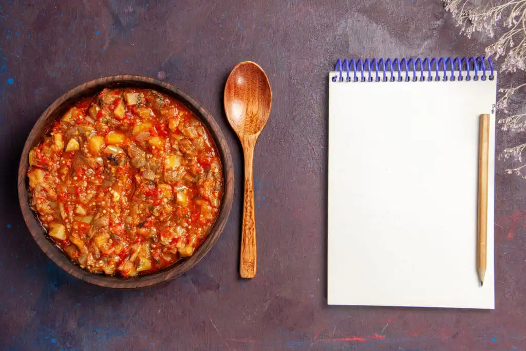 A bowl of hearty beanless chili topped with cheese and sour cream
