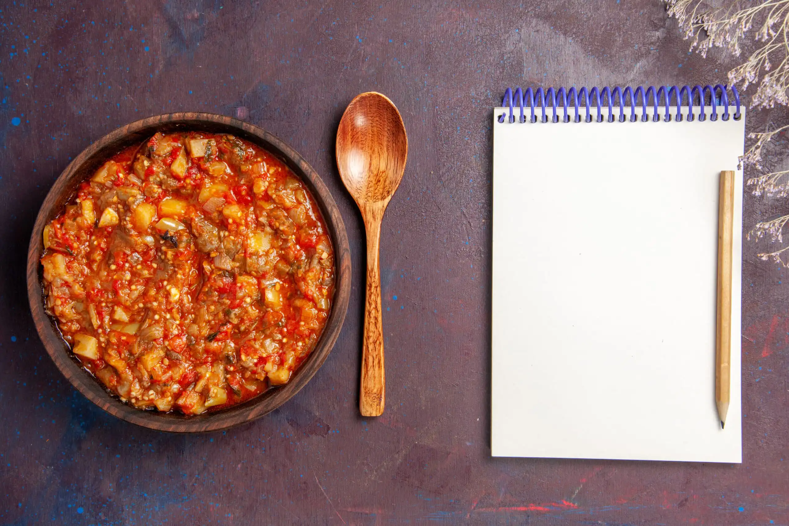 A bowl of hearty beanless chili topped with cheese and sour cream