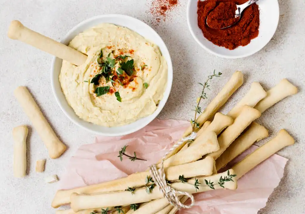 A bowl of creamy Rotel dip with tortilla chips on the side