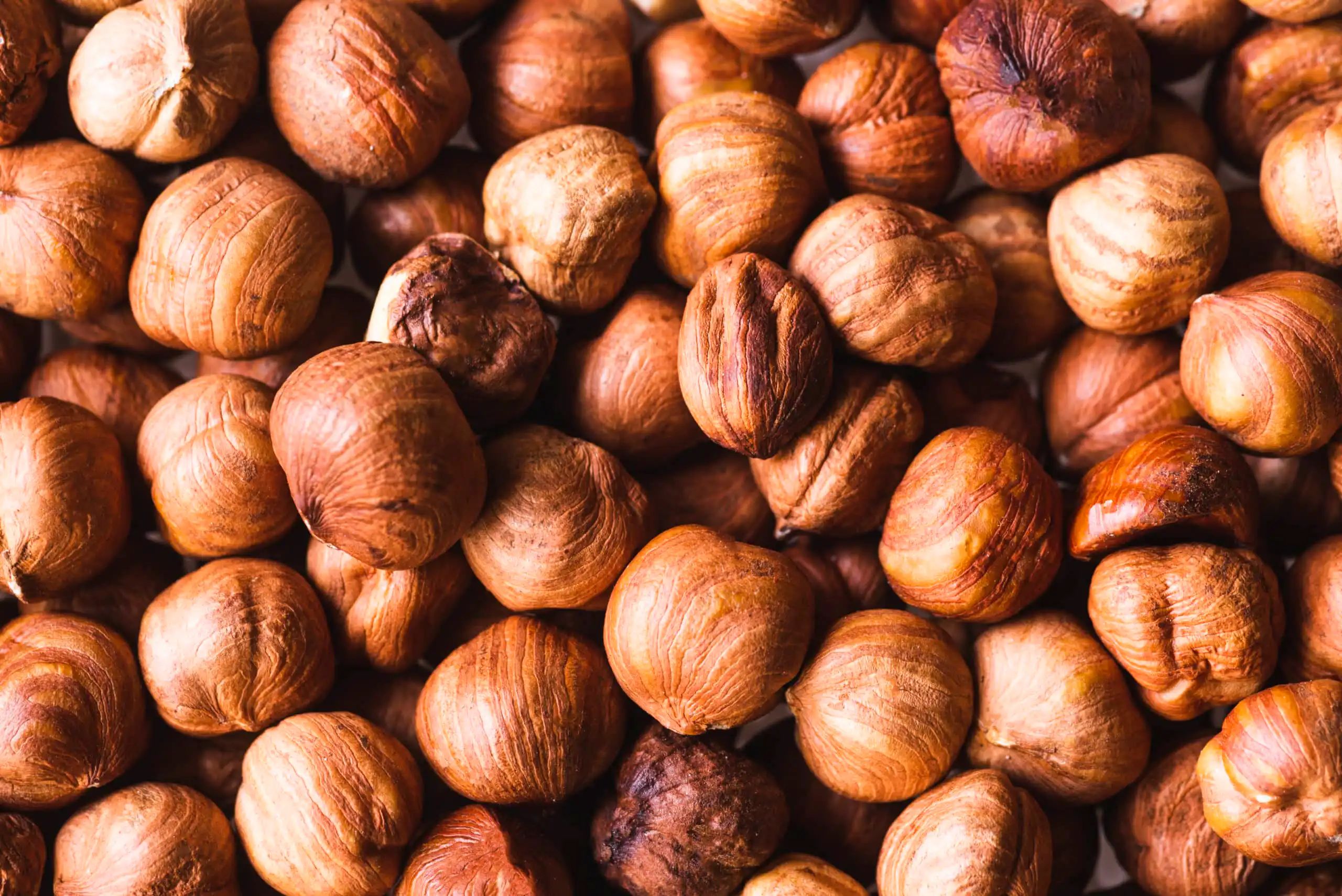Image of chestnuts soaking in a bowl of water, preparing for roasting to enhance flavor and ease of peeling.